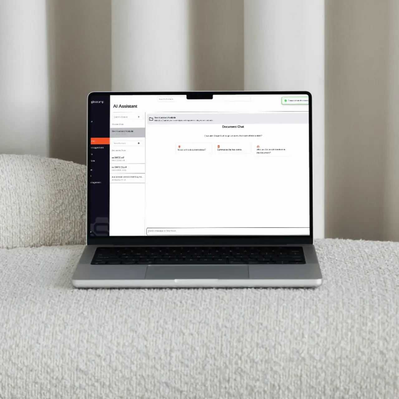 Laptop displaying AI Assistant software on a white textured surface.