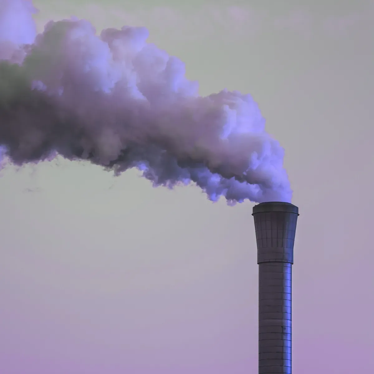 Smokestack emitting a large cloud of industrial exhaust into the sky