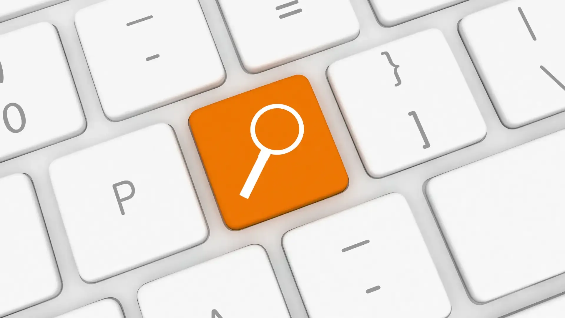 Eine orangefarbene Tastaturtaste mit einem weißen Lupensymbol.