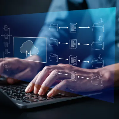Hands on laptop keyboard with digital visualization of cloud storage or a digital archive 