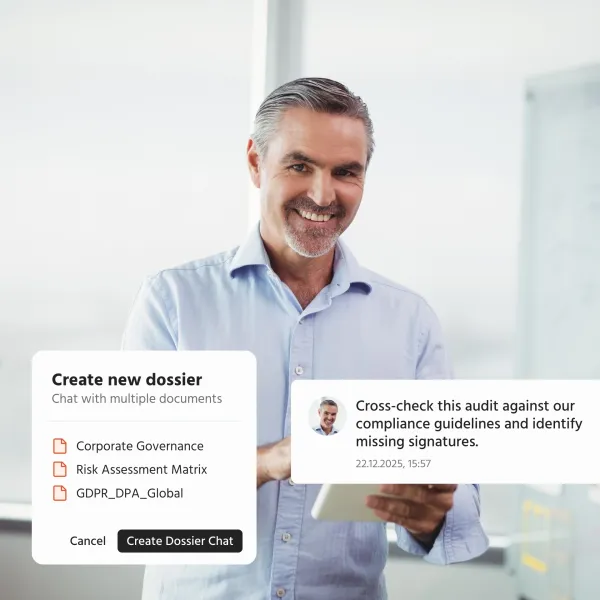 A man smiles while using a document chat feature on a tablet.