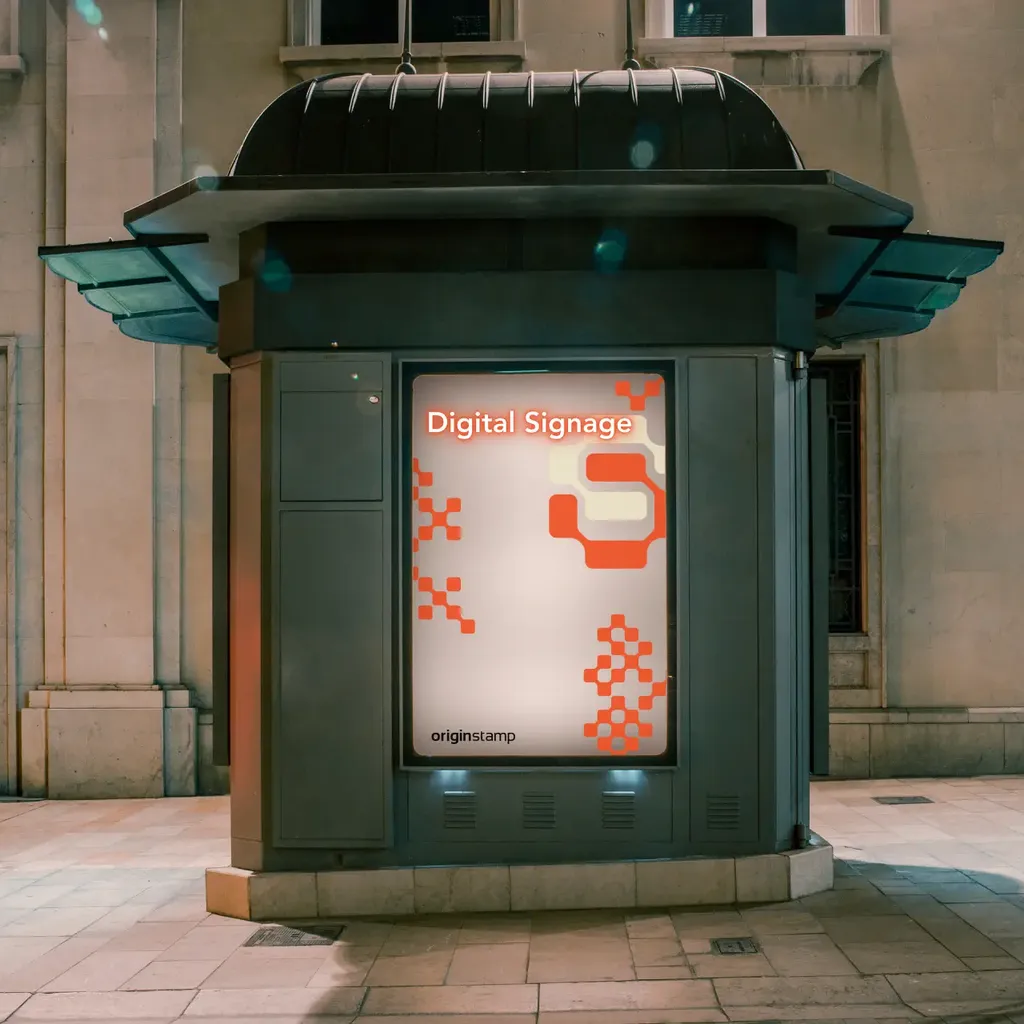 A digital signage kiosk on a city sidewalk at night.