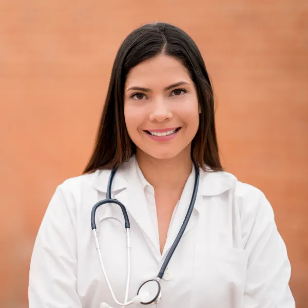 Smiling doctor with a stethoscope against a warm background