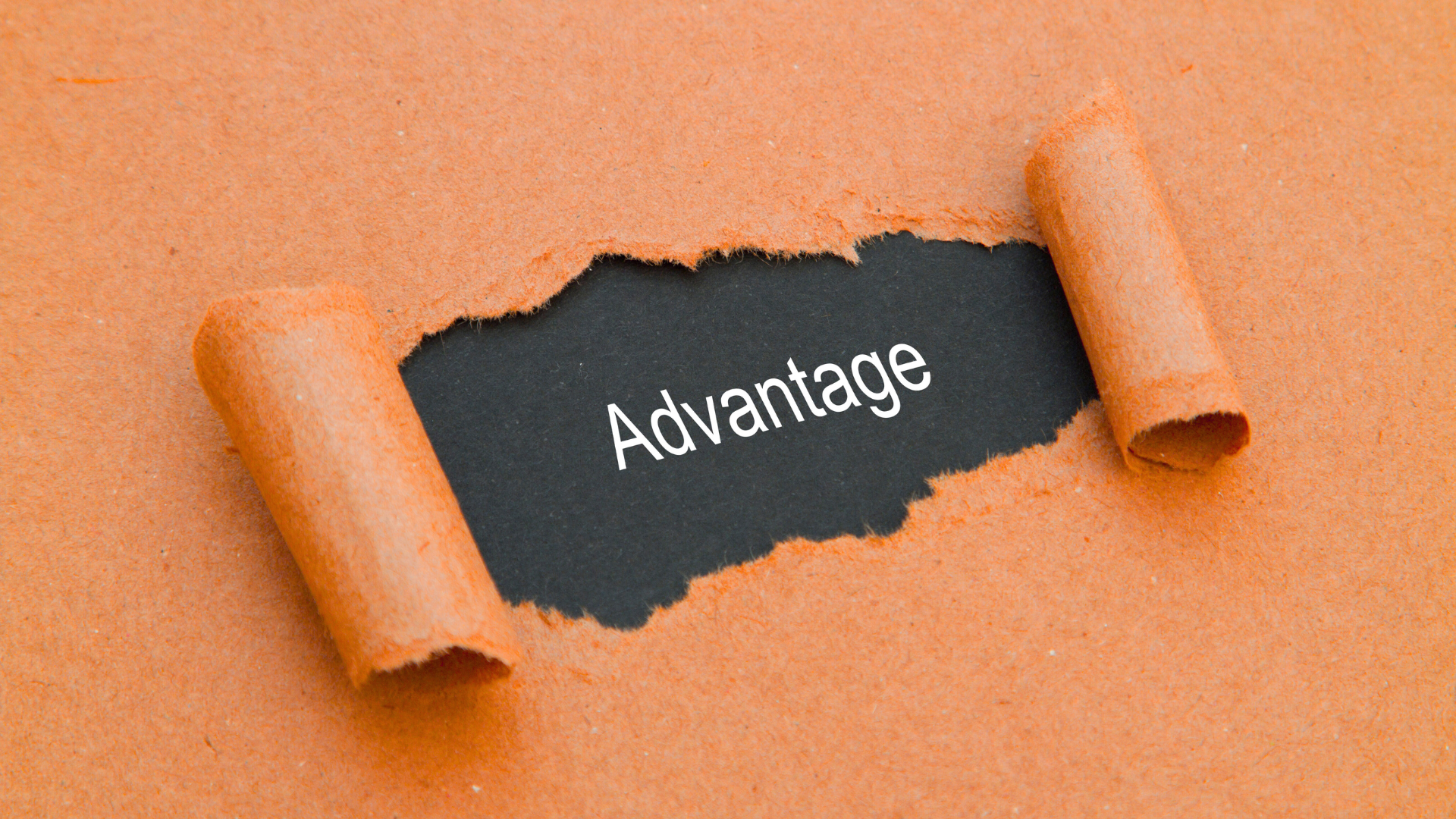 Torn orange paper reveals the word 'Advantage' on a black background.