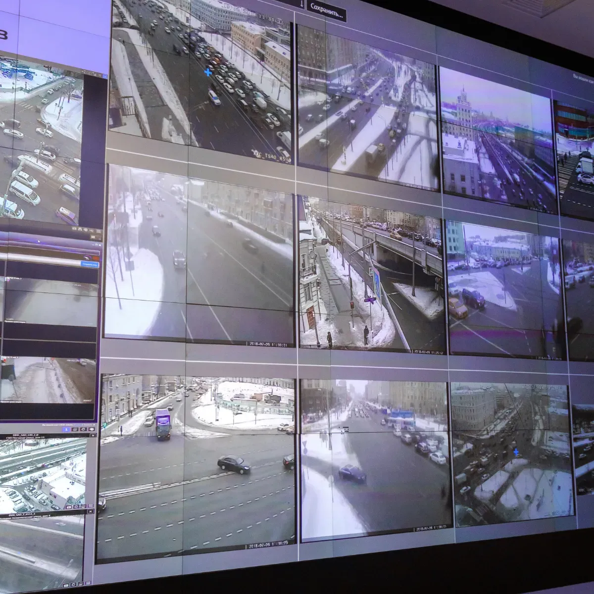 Large video wall displaying live feeds from multiple surveillance cameras