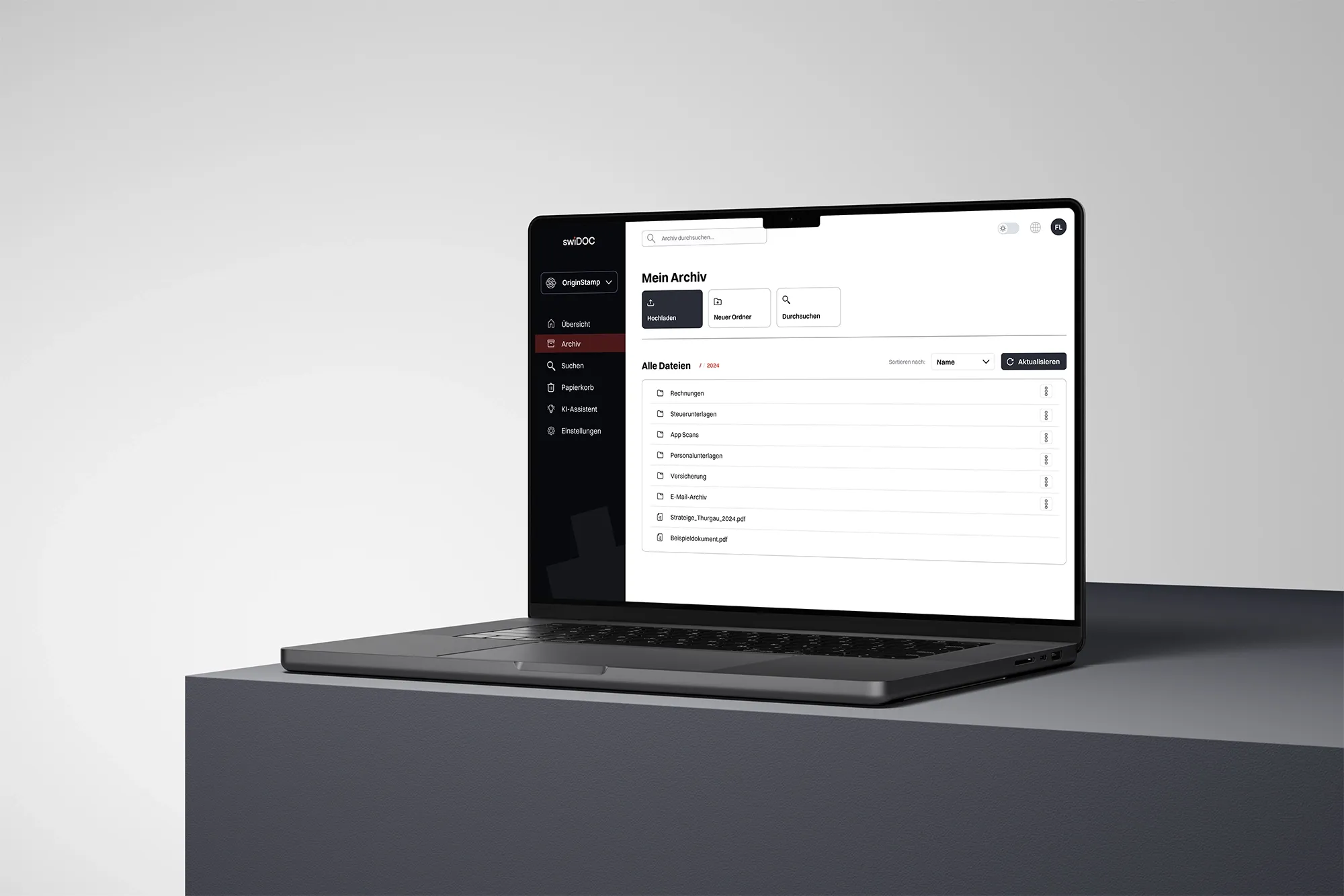 Laptop displaying a digital archive interface with folders and files organized in a clean document management dashboard.