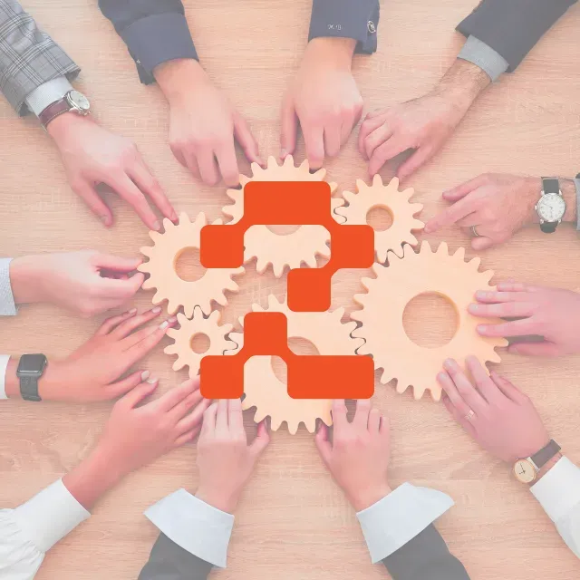 Multiple hands reaching for wooden gears symbolizing collaboration