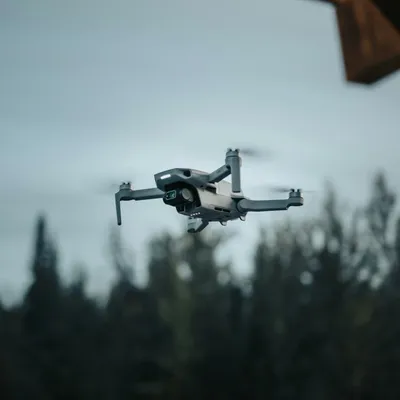 Autonomous drone in flight with a forest in the background
