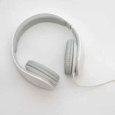 White over-ear headphones lying on a bright background