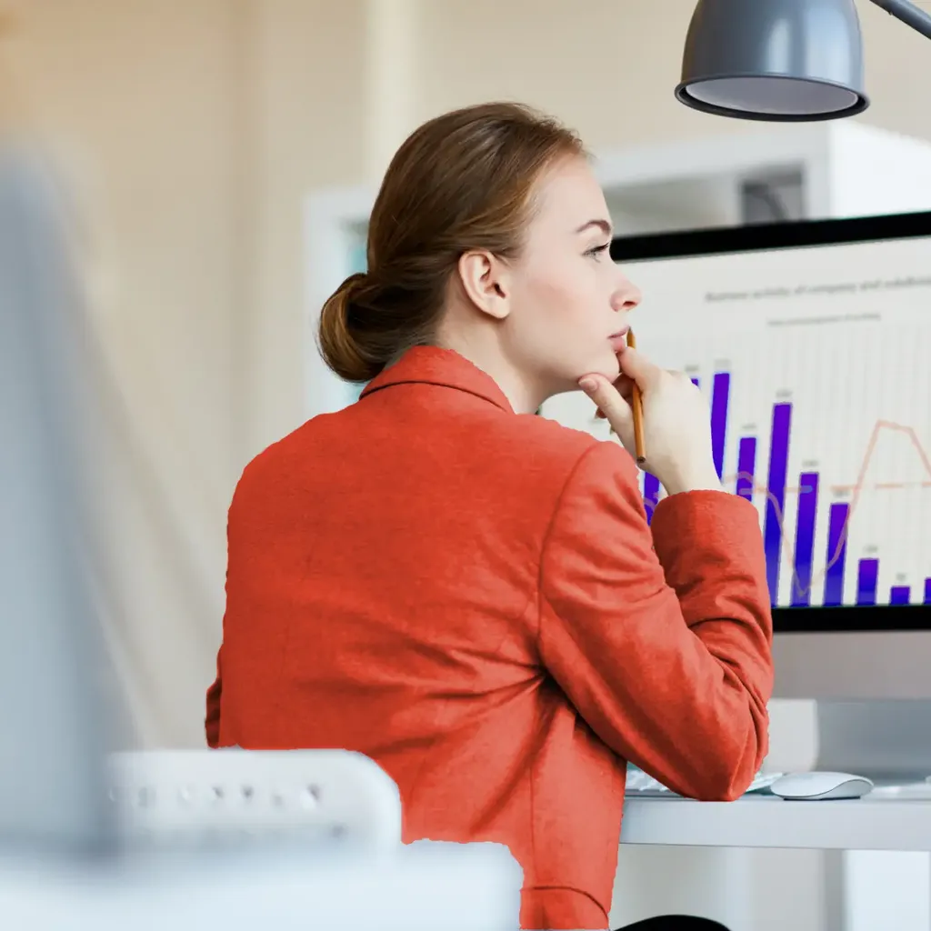 Woman analyzing data charts for predictive analysis on computer dashboard