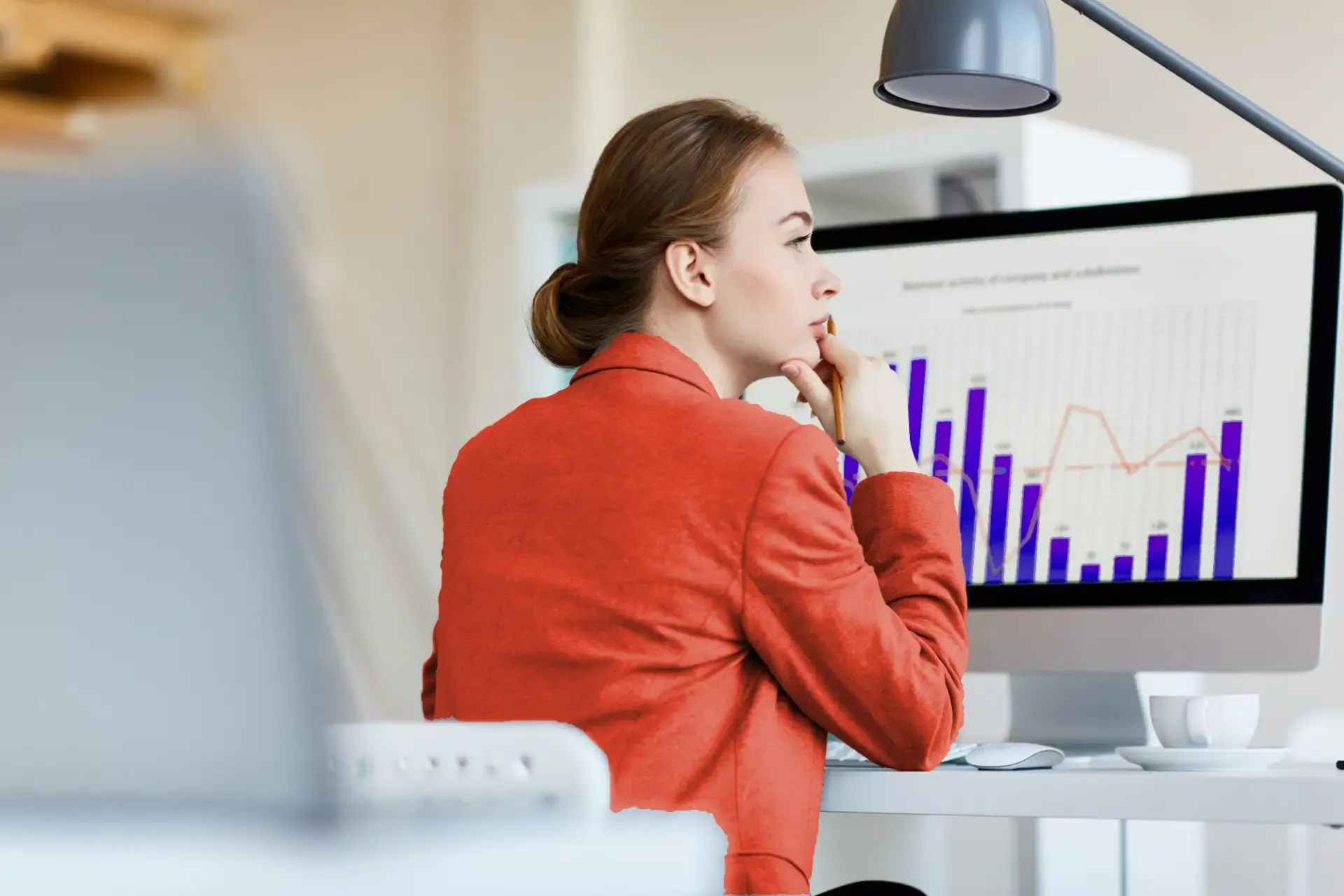 Woman analyzing data charts for predictive analysis on computer dashboard