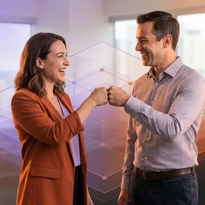 Smiling business colleagues fist bumping in an office with an abstract digital network overlay.